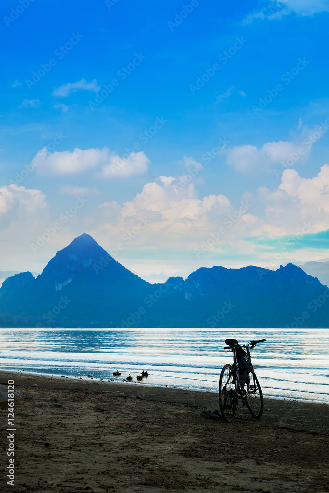 Silhouette of a bicycle in front of the evening sky at the coast Silhouette of a bicycle in front of the evening sky at the coast