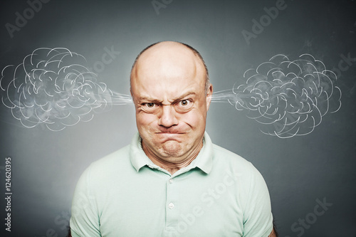 Closeup portrait of angry man, blowing steam coming out of ears,