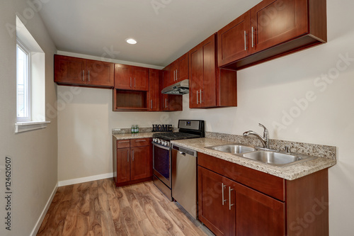 View of burgundy kitchen cabinets with granite counter top