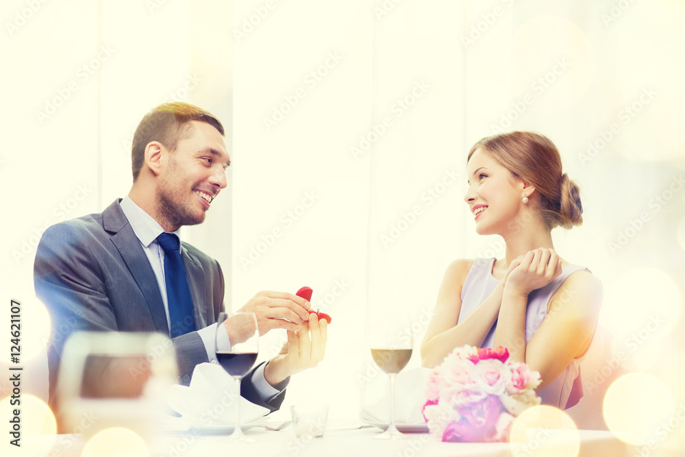 man proposing to his girlfriend at restaurant man proposing to his girlfriend at restaurant