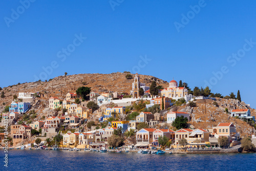 Symi island - Colorful houses and small boats at the heart of the village © STOCKSTUDIO