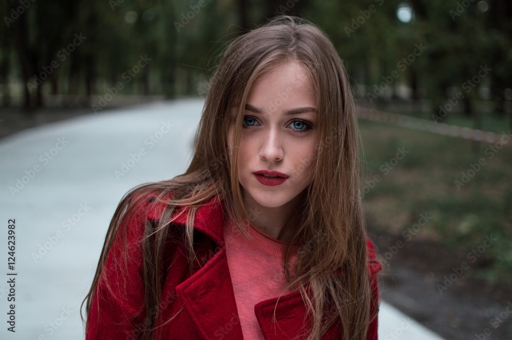 portrait of beautiful girl with blue eyes in red