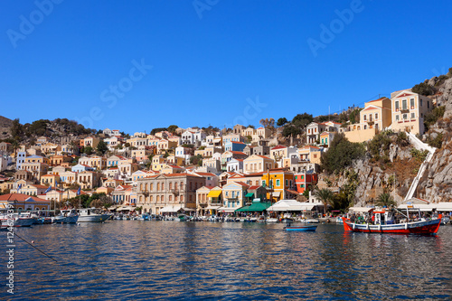 Symi island - Colorful houses and small boats at the heart of the village