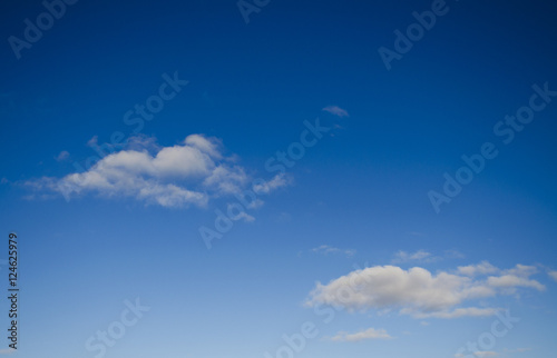 Two white clouds in the blue sky