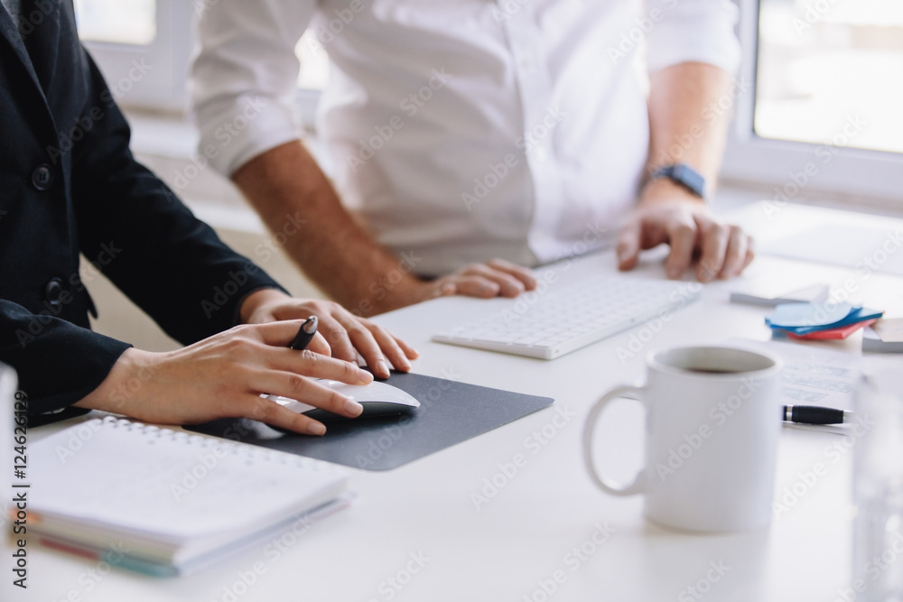 Two business associates working together at office desk Two business associates working together at office desk