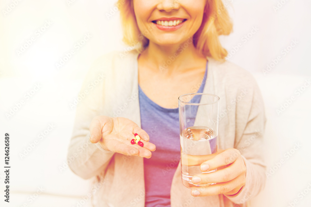 close up of woman with medicine and water glass close up of woman with medicine and water glass