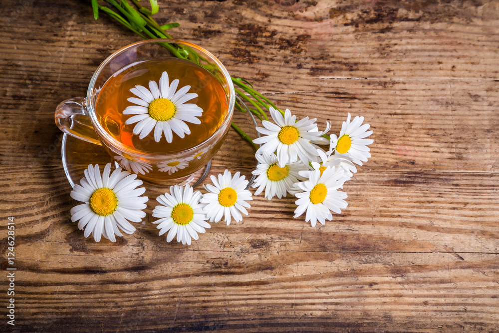 Cup of herbal tea with chamomile flowers Cup of herbal tea with chamomile flowers