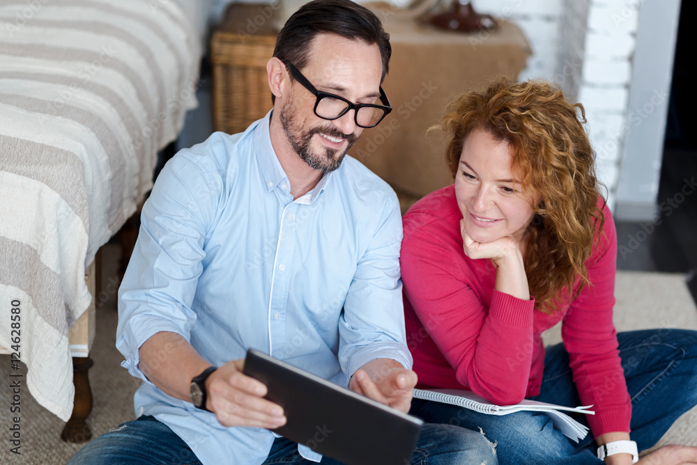 Middle-aged couple using tablet at home Middle-aged couple using tablet at home