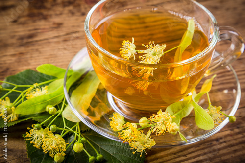Green herbal tea with linden flowers, closeup
