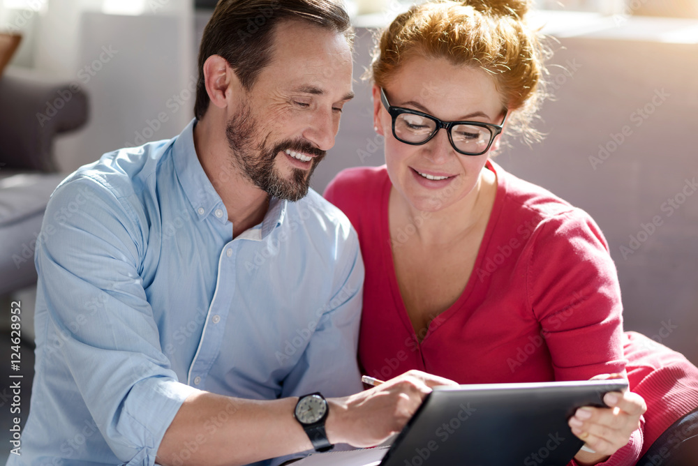 Middle-aged couple using tablet at home Middle-aged couple using tablet at home
