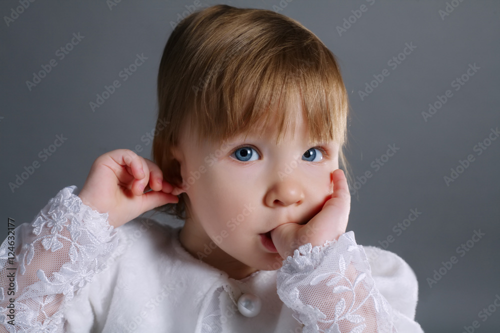 little beautiful girl holding finger in mouth little beautiful girl holding finger in mouth