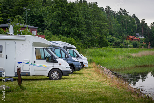 Auto campers parked at lake's shore. photo