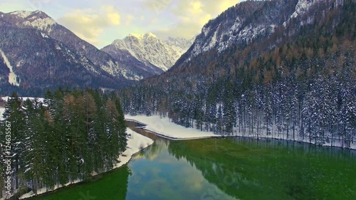 Aerial view of beautiful Jezersko Lake with mountain background on winter time