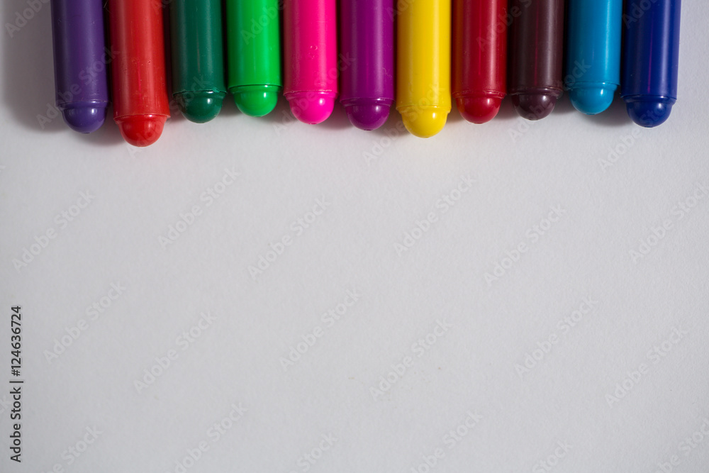 colored crayons and a sheet of paper, notebook concept creativit colored crayons and a sheet of paper, notebook concept creativit