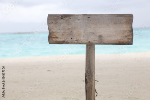 blank wood sign on the beach