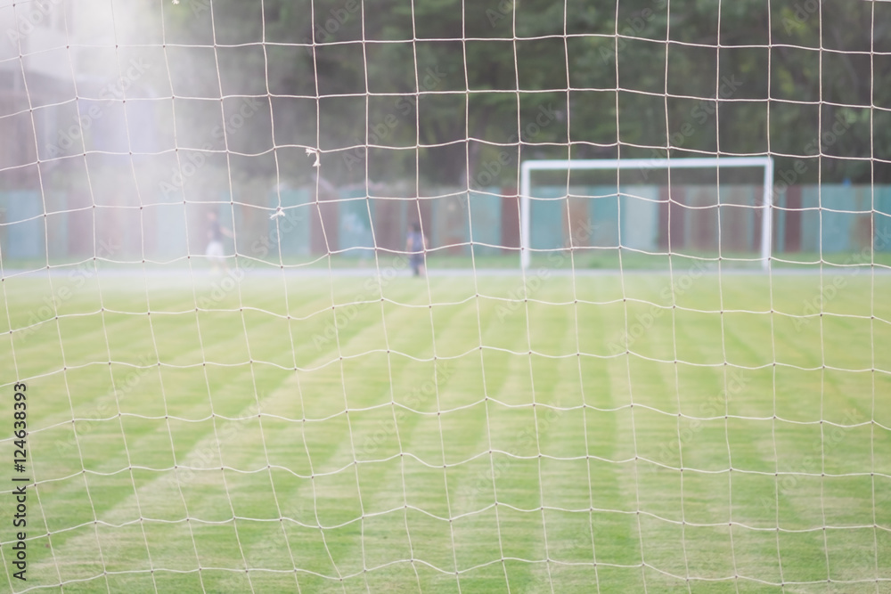 The view behind football or soccer net, background concept The view behind football or soccer net, background concept
