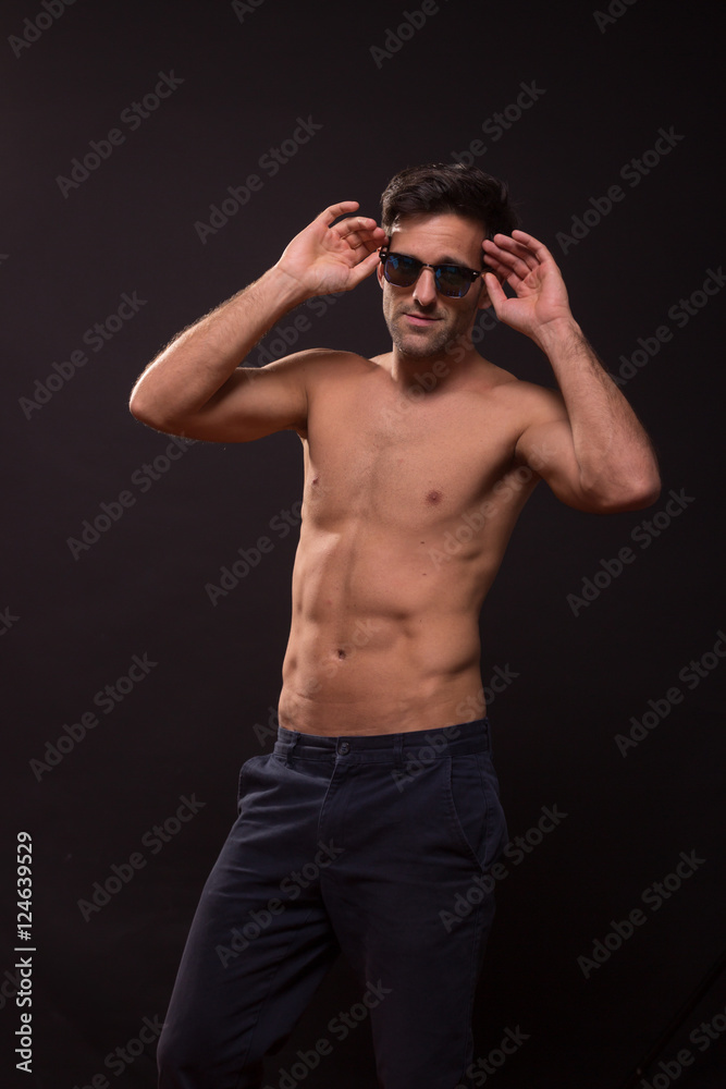 Fototapeta premium confident young man posing abs