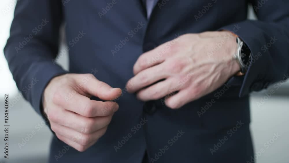 Businessman unbuttoning his jacket Businessman unbuttoning his jacket