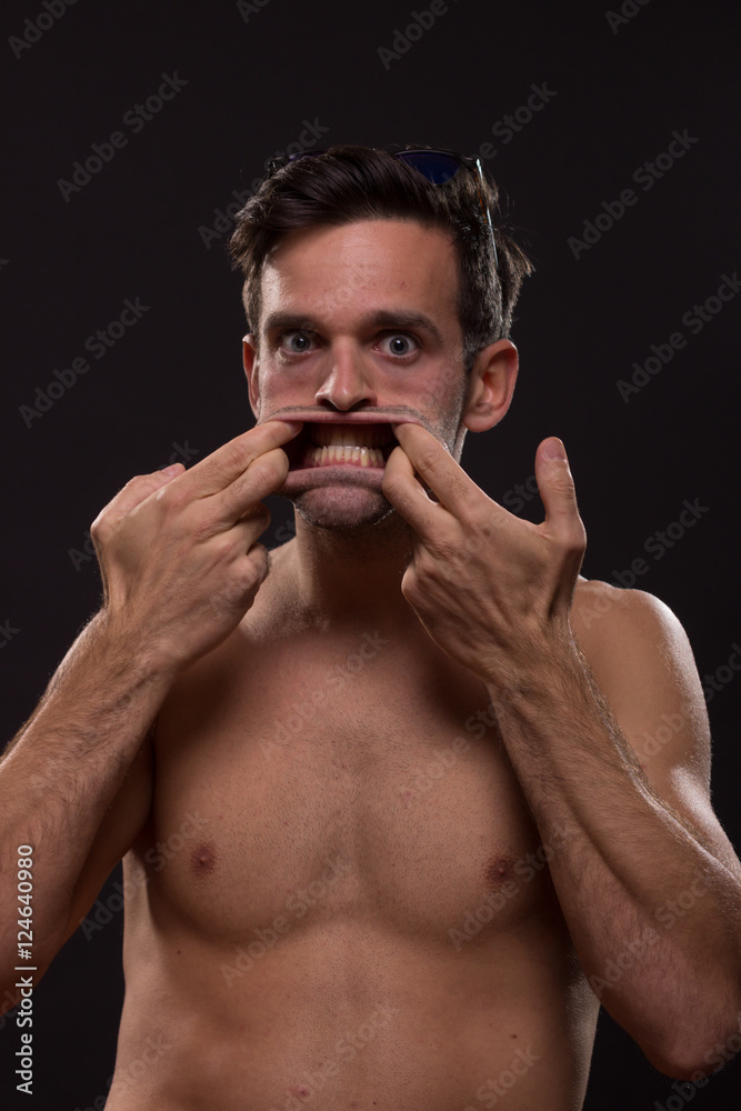 Fototapeta premium crazy young man hands mouth open