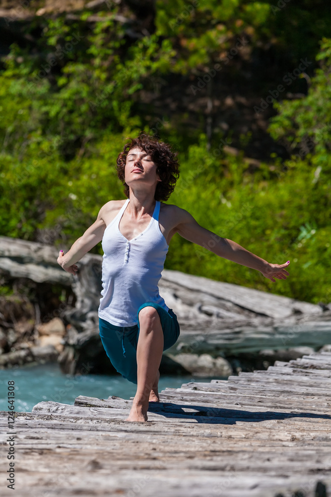 Woman is doing yoga excercises in Altai mountains Woman is doing yoga excercises in Altai mountains