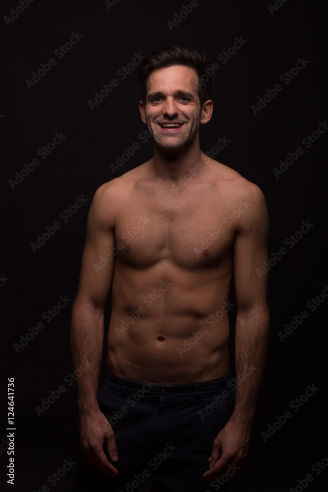 dark moody nude smiling happy shirtless abs young man portrait
