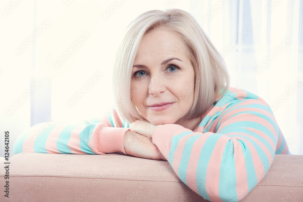 Woman smiling friendly and looking into camera.