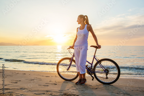  woman on vacation biking at beach