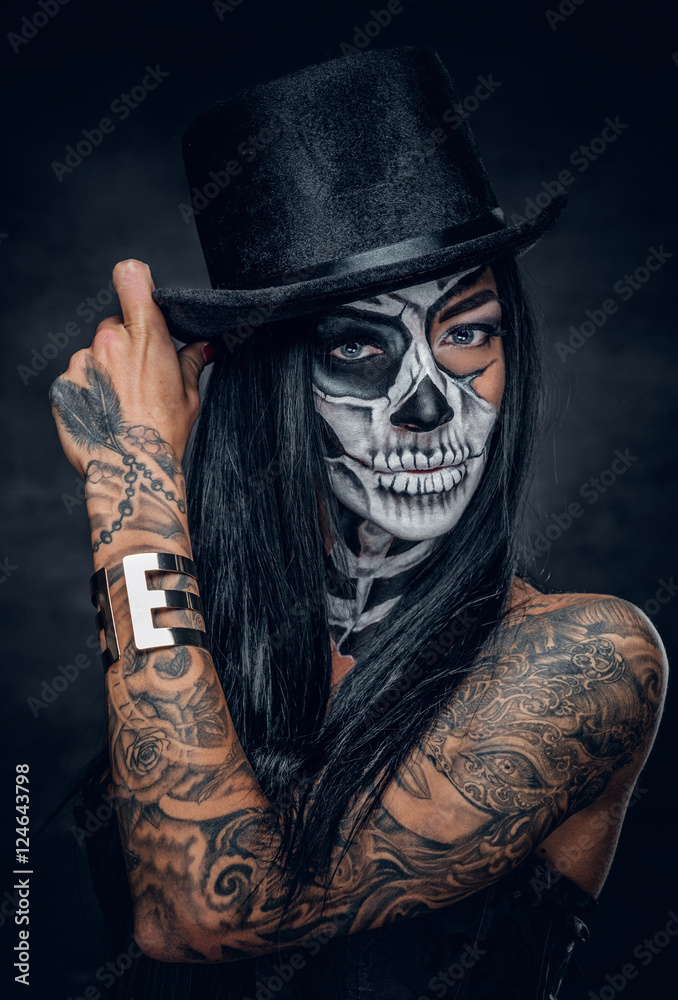 A woman with skull make up in top hat on Halloween. Stock Photo | Adobe  Stock