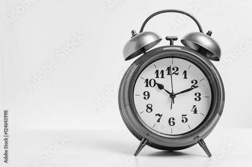 Retro alarm bell clock in black and white tone. Black and white object over white background.