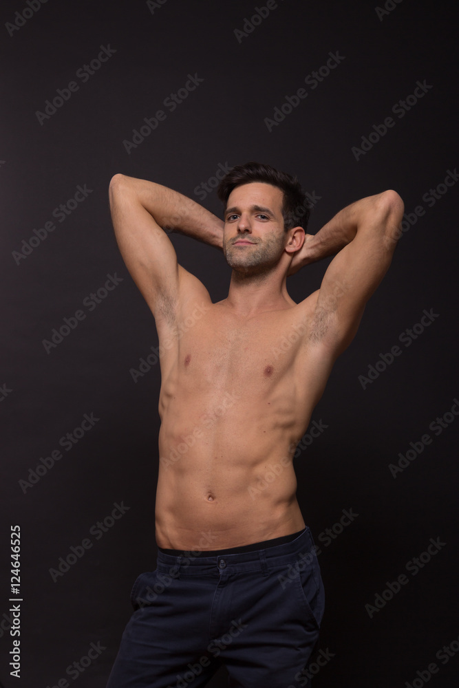 showing off silly young man nude shirtless abs portrait studio