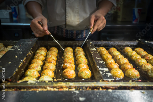 japanese chif cooking takoyaki, tagoyaki is the most popular del