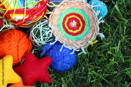 Colorful knitting balls from wool and fabric textile stars on gr
