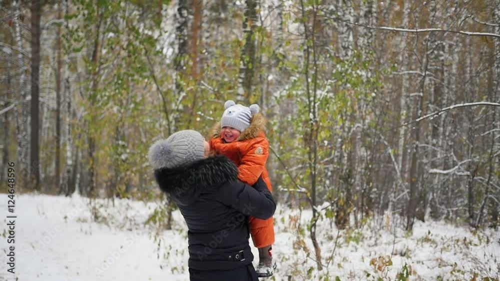 mother playing with baby in winter Park mother playing with baby in winter Park