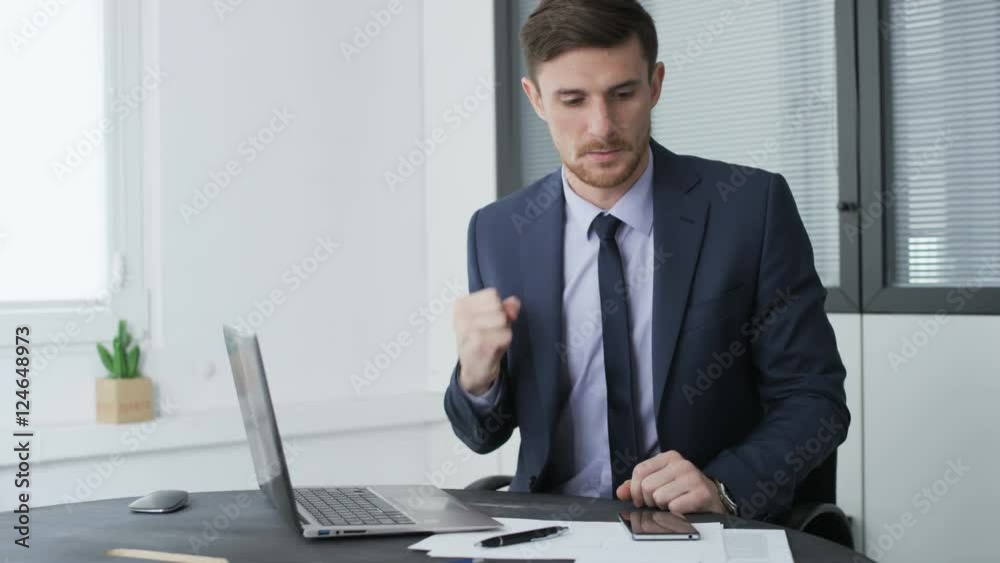 Young businessman making gestures and writing on a piece of paper Young businessman making gestures and writing on a piece of paper