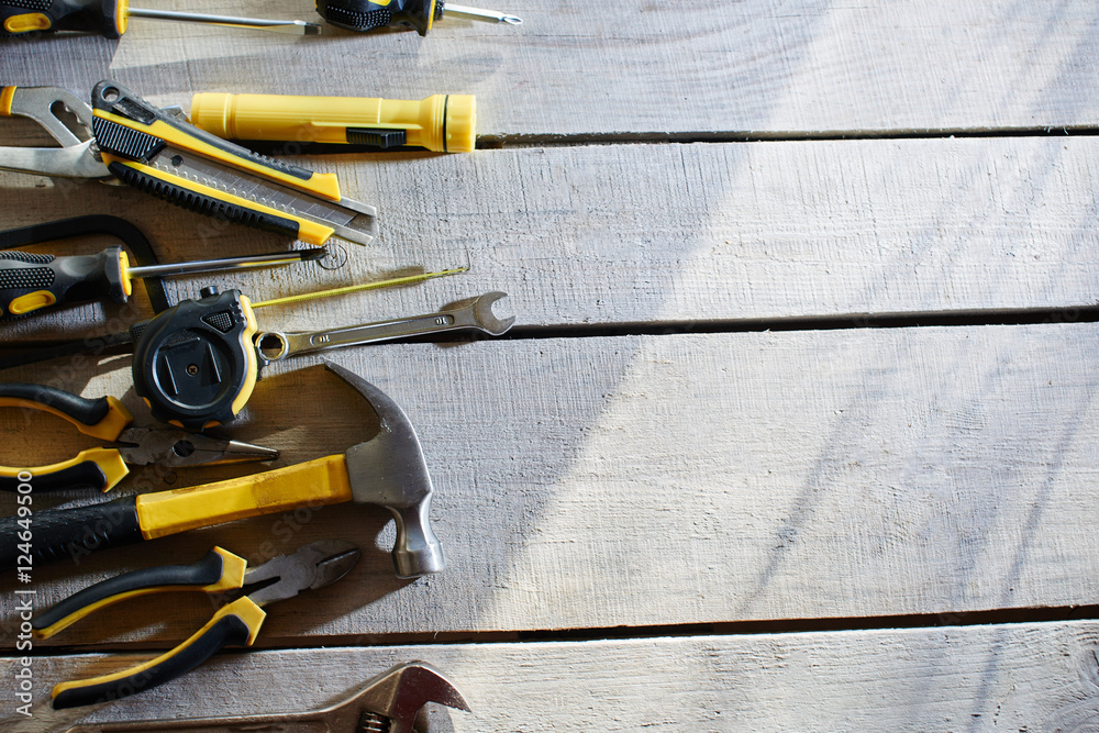 Top view of a set of tools lying on a table of wooden planks Top view of a set of tools lying on a table of wooden planks