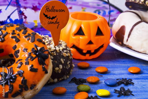 halloween candy and sweets on pink background photo