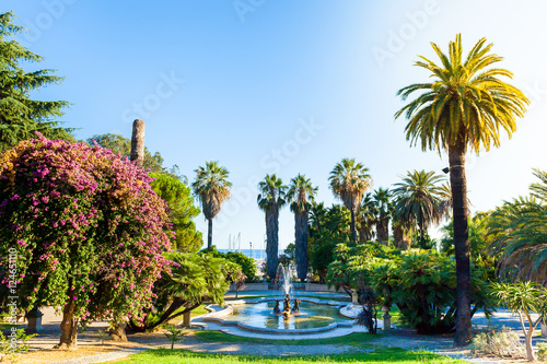 Nobel gardens with a fountain in the foreground, Sanremo, Italy. Classic garden with palm trees and flowers.