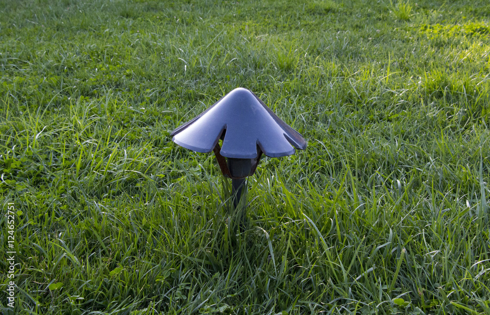 Lawn lamp on green grass.