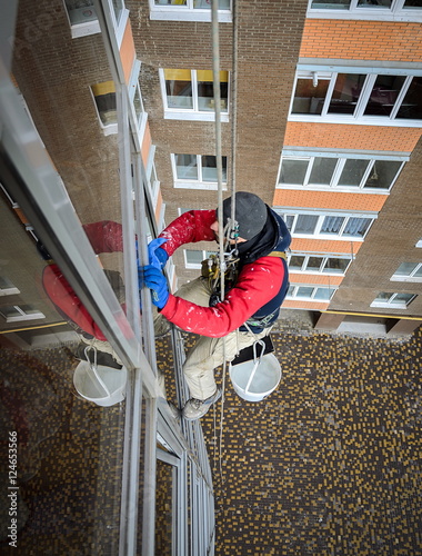 window washer cleans the residential building