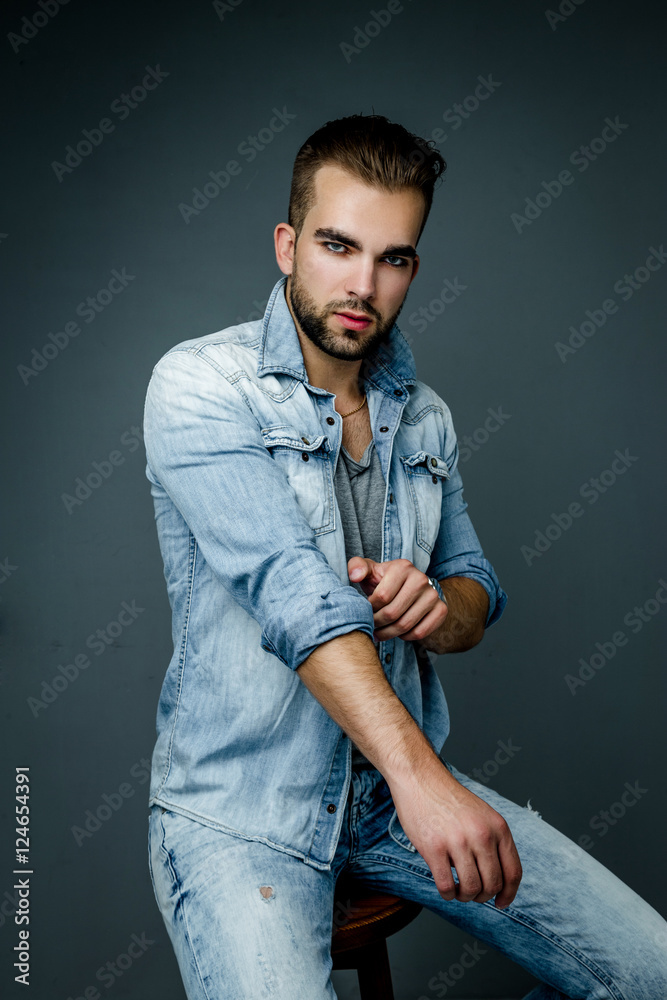 Handsome bearded man wearing jeans shirt, portrait shot in studio