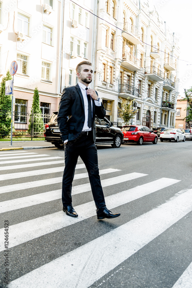 Handsome bearded man wearing suit, portrait shot in urban area Handsome bearded man wearing suit, portrait shot in urban area