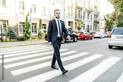 Handsome bearded man wearing suit, portrait shot in urban area