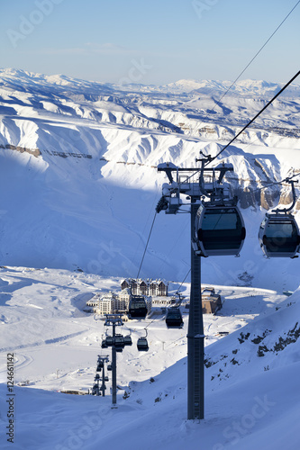 Gondola lift on ski resort at sun evening