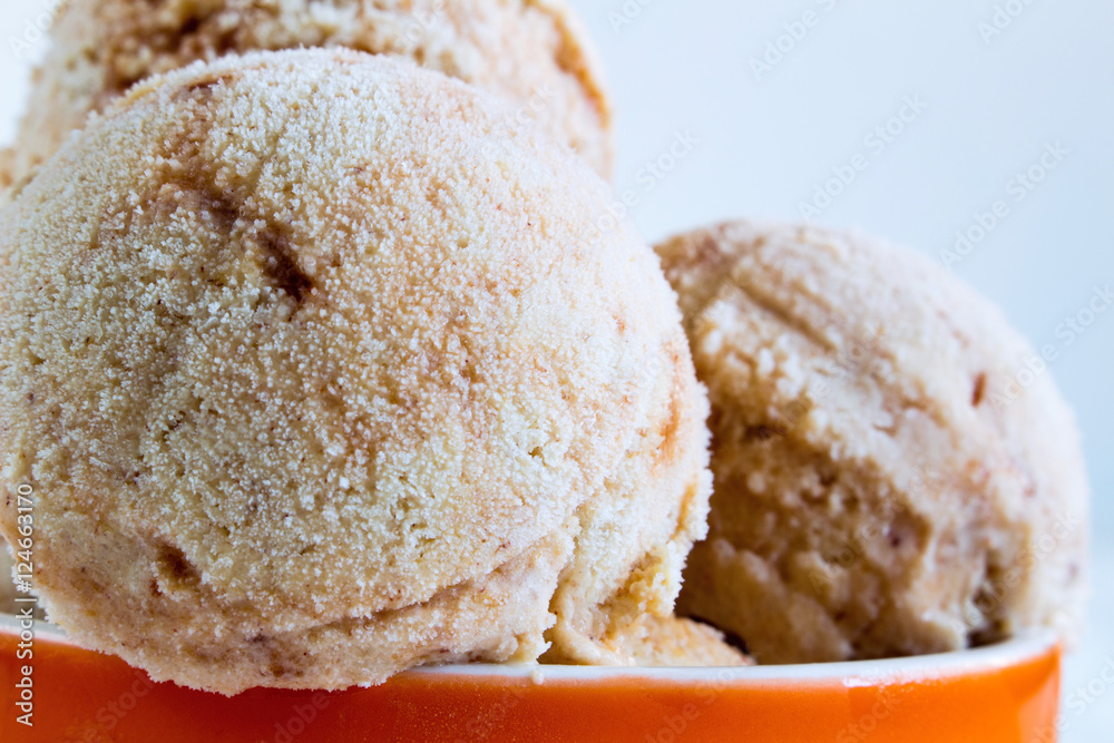 Homemade Ice cream with a persimmon, jam, cardamom on a white wo Homemade Ice cream with a persimmon, jam, cardamom on a white wo