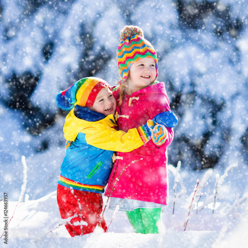 Children playing in snowy winter park