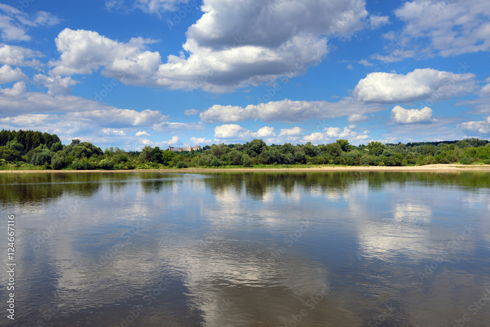 Landscape of beautiful Vistula river at summer day. Reflections of clouds in water. Poland, Europe.
