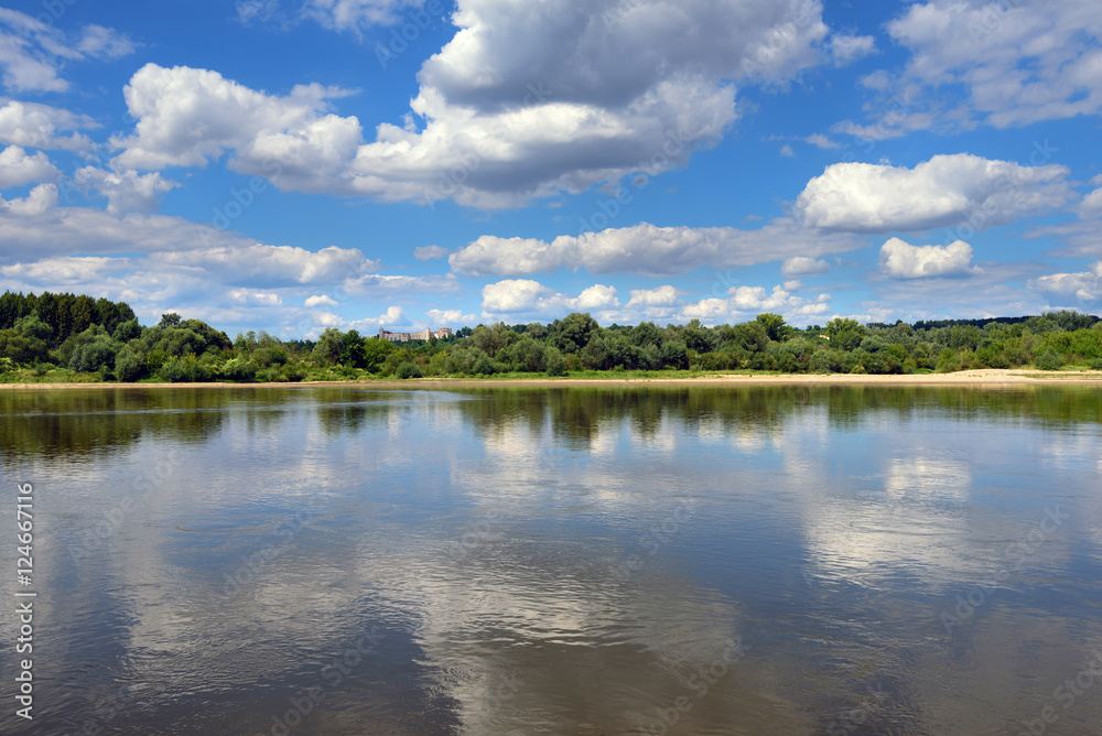 Obraz premium Landscape of beautiful Vistula river at summer day. Reflections of clouds in water. Poland, Europe. 