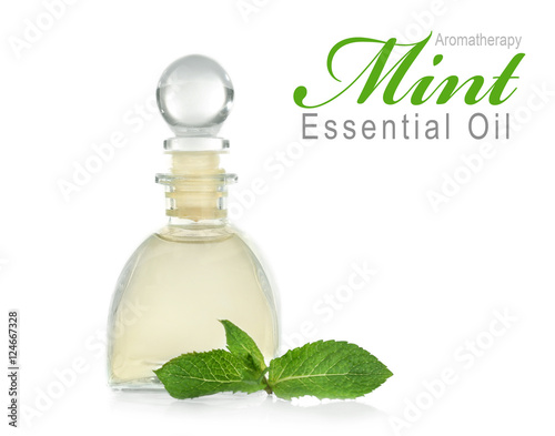 Glass bottle of essence, closeup. Text AROMATHERAPY MINT ESSENTIAL OIL on white background. Spa beauty concept.