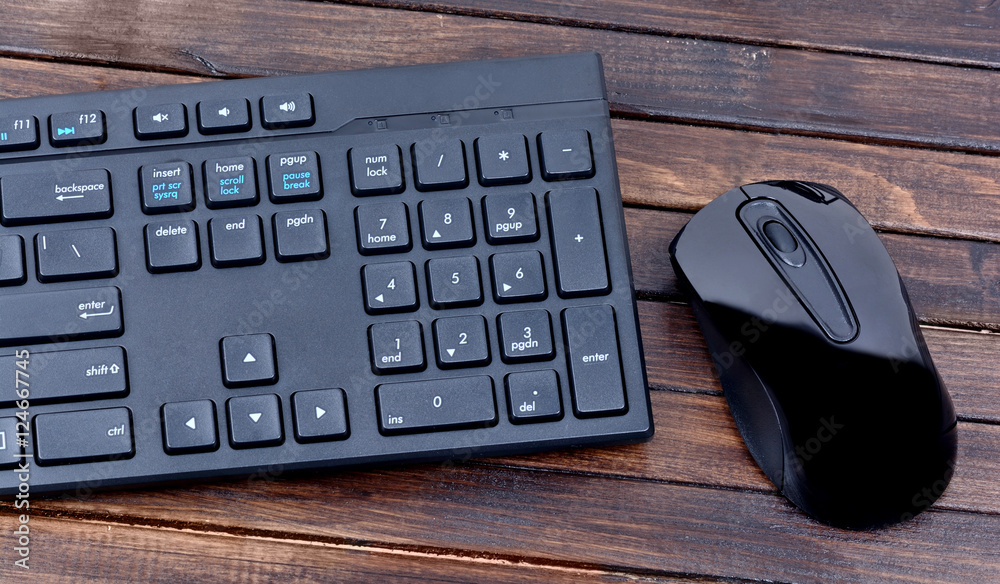 Keyboard computer with mouse on wooden background Keyboard computer with mouse on wooden background