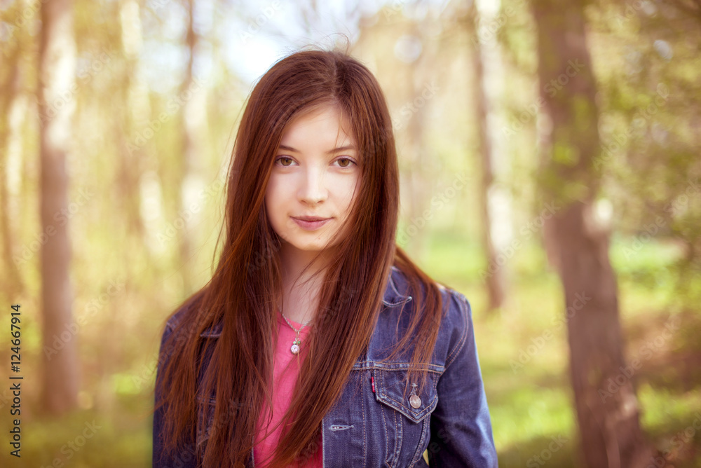 Portrait of a girl with long straight brown hair, which fly in t Portrait of a girl with long straight brown hair, which fly in t